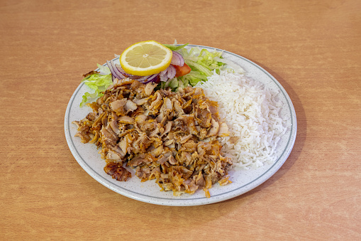 Menu mixed kebab dish garnished with basmati rice and salad with red onion and lemon tomato for seasoning