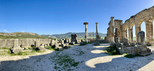 Morocco, 22-03-2023: the remains of the Roman basilica in Volubilis, the most famous Roman archaeological site in Morocco, near Meknes, at the foot of Zerhoun mountain