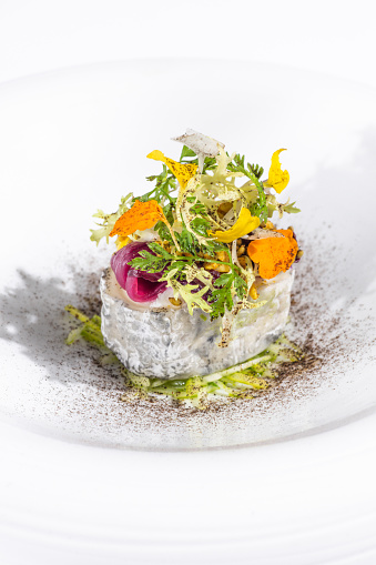 French Goat Cheese dish with salad and herbs at gourmet fine dining Michelin Restaurant