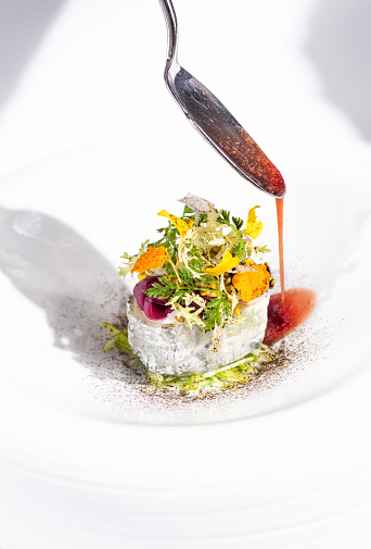 French Goat Cheese dish with salad and herbs at gourmet fine dining Michelin Restaurant