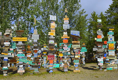 The Sign Post Forest is the famous attraction of Watson Lake on the Alaska Highway. Travelers from all over the world bring signs and put them on poles – Watson Lake, Yukon, Canada