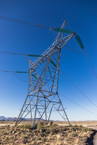 Single high voltage electrical transmission tower in South Africa in a rural area