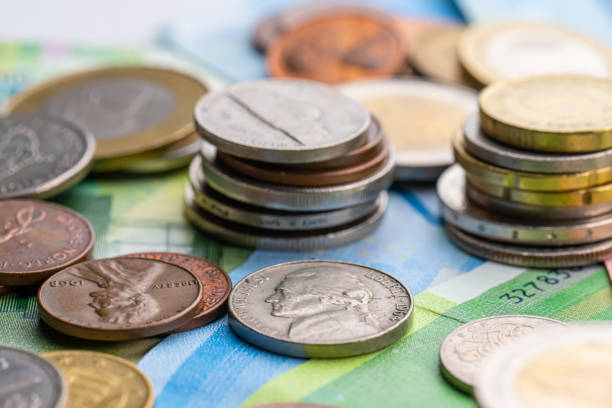 istock Stacks of coins on bank notes. 1482650116