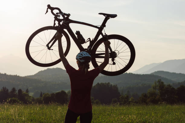 istock Racing female cyclist raising bicycle with both arms above her head 1482650212