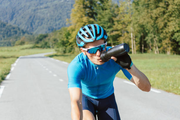 istock Male cyclist drinking water, tracking shot. 1482650792