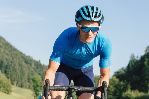 istock Racing cyclist riding on the road through a forest 1482650801