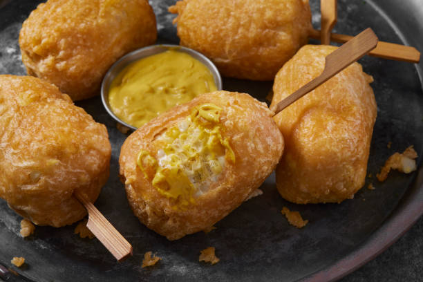 Beer Battered Corn on the Corn Beer Battered Corn on the Corn with Spicy Mustard Dip corn cob eaten stock pictures, royalty-free photos & images