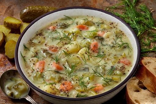 Creamy Polish Dill Pickle Soup with Potatoes, Carrots, Celery, Fresh Dill and Bread