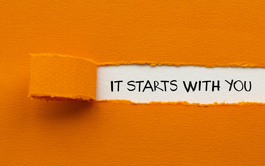 The motivational quote. Ripped orange paper.
