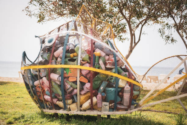 Colorful decorative recycling plastic cage in fish shape by the beach