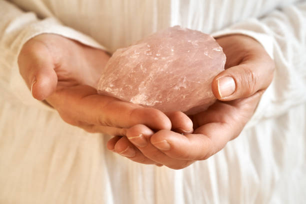 istock Woman holding a rose quartz stone 1482659186