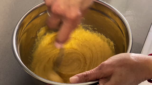 Mixing eggs with almond flour to make cake