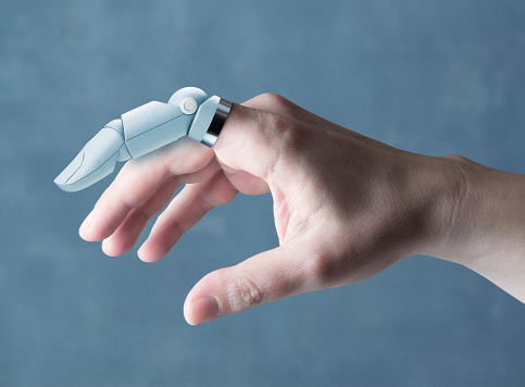 Human hand with futuristic robot finger