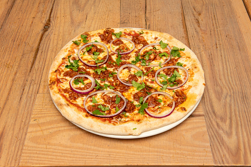 Great BBQ pizza with raw red onion rings and lots of parsley. Minced meat with tomato and baked wheat flour dough