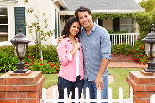 istock Hispanic couple outside new home 148267511