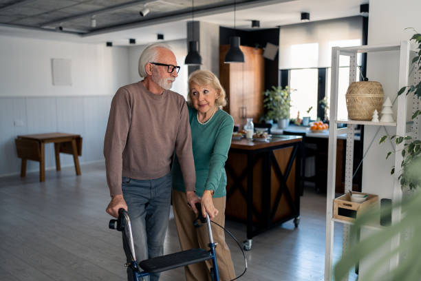 istock Supportive wife helping husband to use mobility walker 1482675327