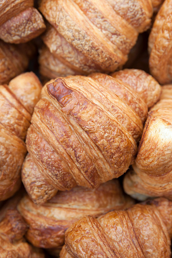 Close-up of freshly-baked golden croissants on display at a farmer's market