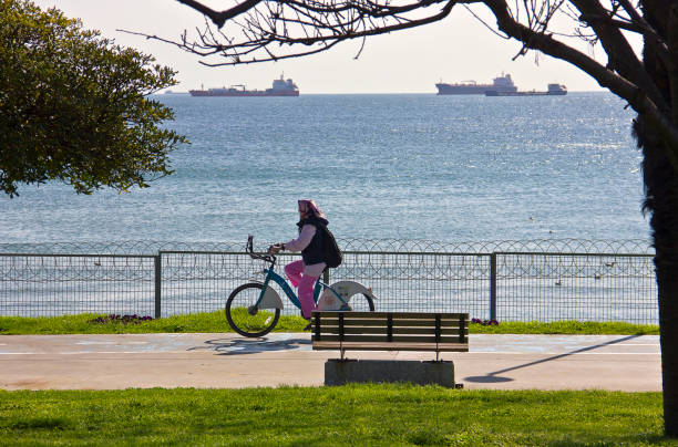 Istanbul, Turkey - April 8, 2023: People resting and walking near sea at Florya bakırköy istanbul near marmara sea in a sunny spring day.