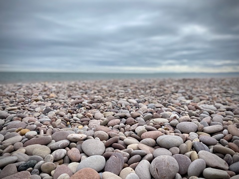Pebble beach devon, sea, cloudy sky. Stones, rounded.