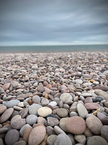 Pebble beach devon, sea, cloudy sky. Stones, rounded.