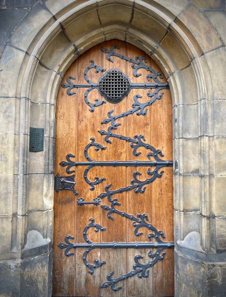 istock Pretty decorative wooden door with cast hinges. 1482678486
