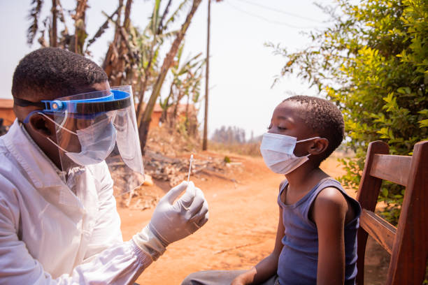 A doctor holding a swab to perform a molecular test on a child in Africa A doctor holding a swab to perform a molecular test on a child in Africa. ebola stock pictures, royalty-free photos & images