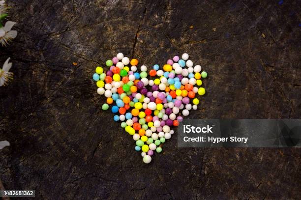 Heart Shape Made From Colorful Nonpareils Sprinkle Decorations Wooden  Background Stock Photo - Download Image Now - iStock