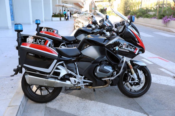 Monte-Carlo, Monaco - April 16, 2023: Two impressive BMW R 1250 RT motorcycles in black and red, part of Monaco's police force, parked outside the Larvotto precinct with blue lights mounted at the rear in Monaco Monte-carlo