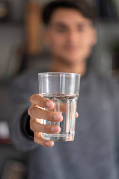 istock Young man holding water glass 1482684422