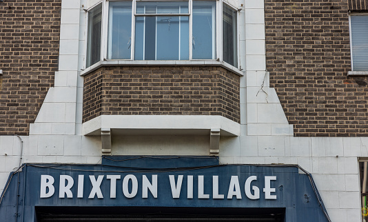 The entrance to the Brixton village market. A shopping arcade with global food restaurants and local independent traders, dating back to the 1960s.