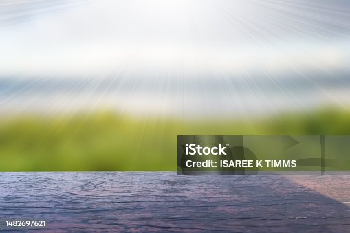 istock Wooden picnic table on ocean blurred background 1482697621