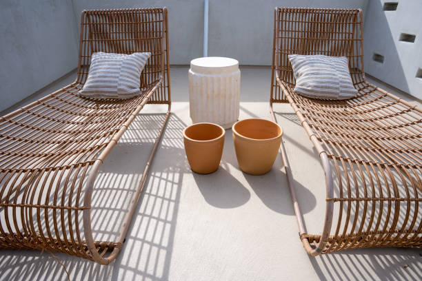 istock Two wicker sun lounge chairs on a roof sun deck. 1482698040