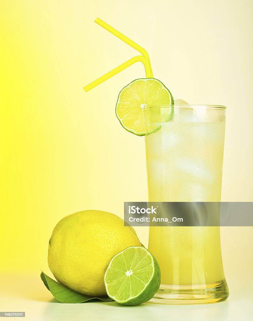 Fresh lemon juice Fresh lemon juice, tasty cold lime drink, healthy fruits and icy beverage, sweet refreshing lemonade, tropical citrus cocktail, full glass of alcohol isolated on yellow background, food still life Alcohol - Drink Stock Photo