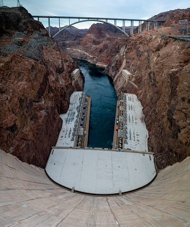 The Hoover Dam towers above the Colorado River, a marvel of engineering and a testament to human ingenuity. Built during the Great Depression, the dam provided thousands of jobs and transformed the arid landscape of the American Southwest, generating hydroelectric power and providing water for irrigation and drinking. The massive concrete structure spans the Black Canyon, holding back the mighty Colorado River and creating the vast Lake Mead. Visitors can take guided tours of the dam's interior, marveling at the complex machinery and learning about the history of this iconic landmark. The Hoover Dam stands as a symbol of American resilience and resourcefulness, a testament to the power of human cooperation and determination.