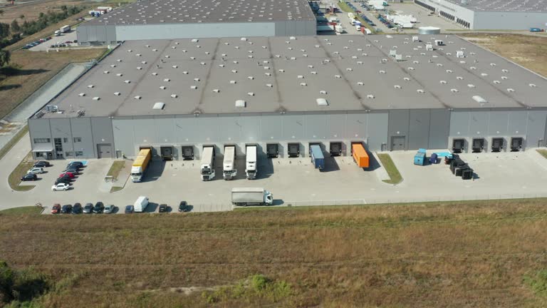 Large logistics park with a warehouse, a loading hub with many trucks