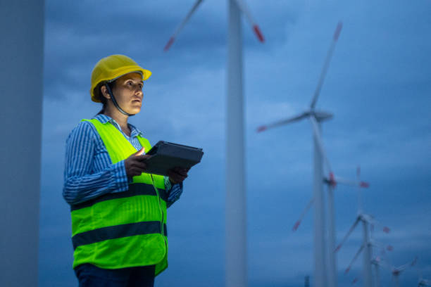 istock Pregnant wind energy engineer working late at wind farm. 1482703421