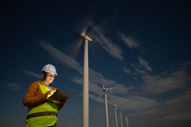 istock Pregnant wind energy engineer working late at wind farm. 1482703432