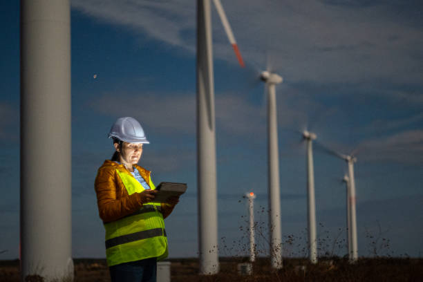 istock Pregnant wind energy engineer working late at wind farm. 1482703433