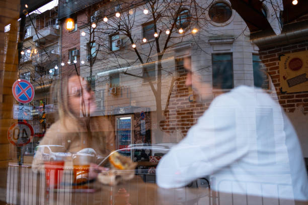 Having coffee together in a local coffee shop.
