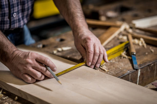 istock Carpenter measuring wood with meter instrument 1482703730