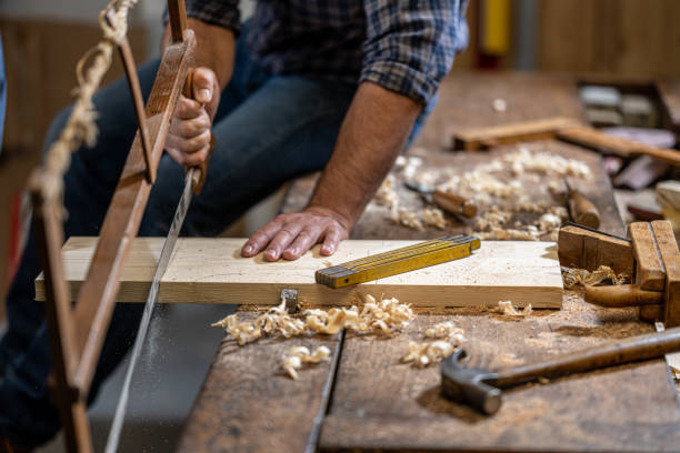 istock Man cutting wooden plank with hand saw 1482703732