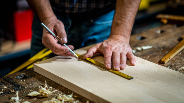 istock Carpenter measuring wood with ruler 1482703745