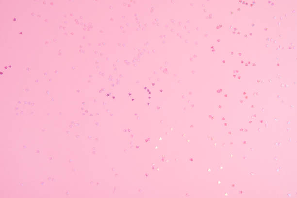 istock Pink pastel background with small hearts confetti. Flatlay, top view, copy space 1482704186