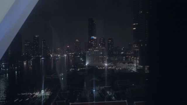 Hands take video of Bangkok city skyline, rack focus shot, smartphone view, unrecognizable
