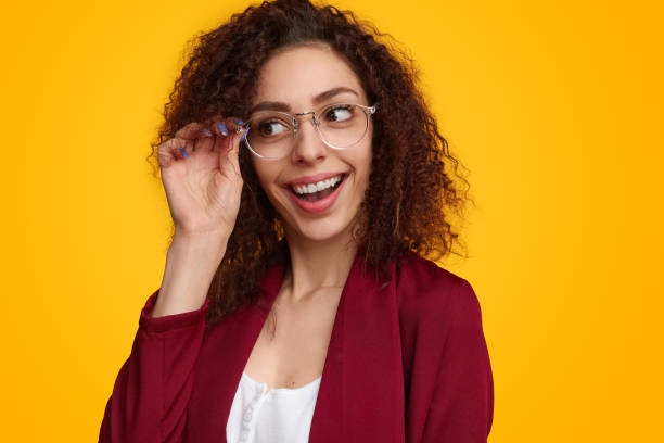 istock Excited young lady adjusting eyeglasses and looking away in studio 1482706459