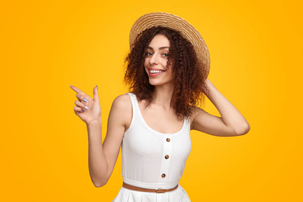 istock Happy woman pointing away in summer 1482706469