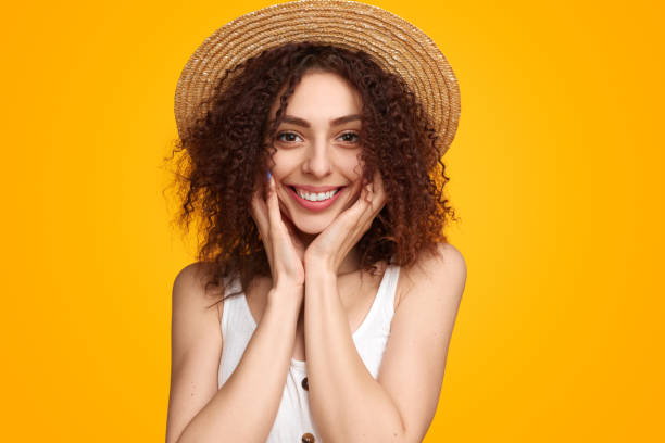 istock Charming women in straw hat touching cheeks 1482706474