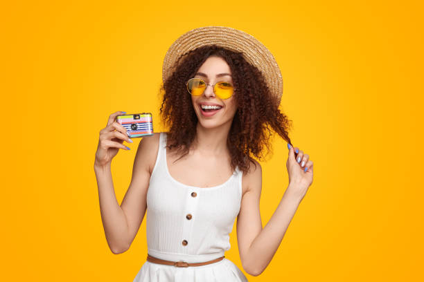 istock Cheerful woman in summer with a camera 1482706477