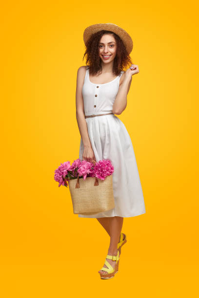 istock Charming woman with flowers in wicker bag 1482706486