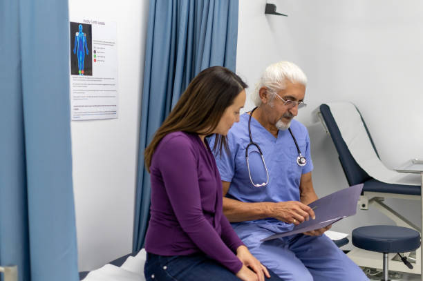 istock Doctor reviews patients test results with her 1482708567